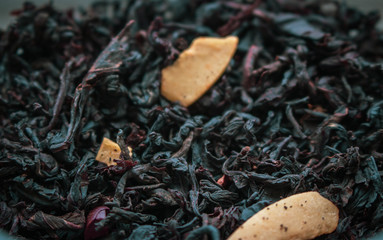 Flower tea leaves close up. Dry black tea with fruit slices. Aromatic herb. Sweet organic tea....