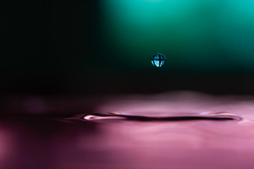 close up of a water droplet in a colourful image