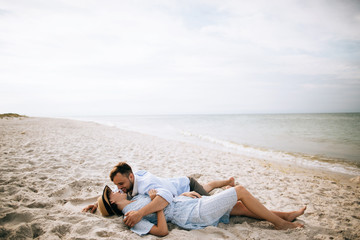 Summer vacation of a young family on the sea beach