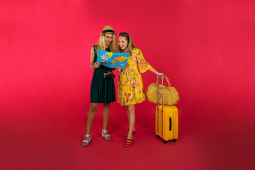 Pretty tourist looking the map and smiling