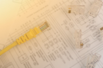 Topical Internet and Network Technology: Top view of network cable and plugs for utp wire over structured cabling network map. Concept of technological services, networks and internet service.