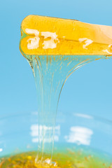 Depilation and beauty concept - sugar paste or honey wax for hair removing spatula with wooden...
