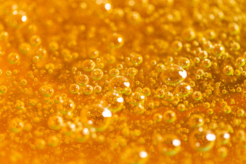 Liquid yellow paste for sugaring close-up. Depilation and hair removal concept. Macro photo.