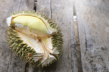 Durian riped and fresh with yellow colour on wooden table.