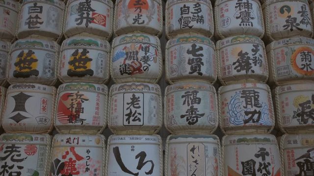 Close up of barrels of sake wrapped in straw in Yoyogi Park near Meiji Shrine. Japanese idiom with colorful designs