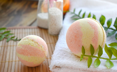Still life spa resort treatment with bath bombs and towel on wooden background. Natural...