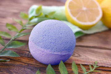 Close up aromatherapy spa design with bath bomb and leaves on wooden background. Natural scented...