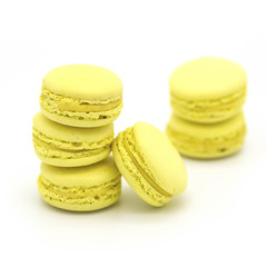 Yellow lemon macarons on a white background