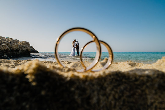 large rings on the sand and a small lovers on the horizon 