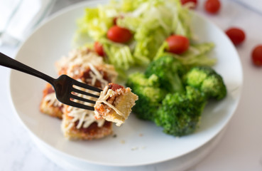 Tofu Parmigiana dish with tomato sauce and cheese