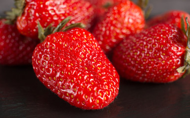 Directly above view of strawberry on black stone background.