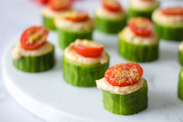 Cucumber bites with hummus and Tomatoes 