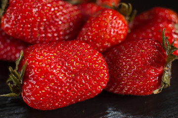 Directly above view of strawberry on black stone background.