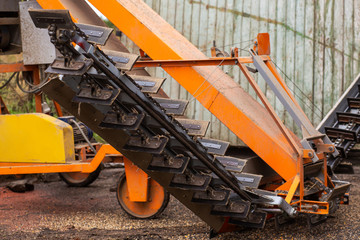 A machine for extracting seeds from sunflowers in a hangar. Mountain of sunflower seeds. Harvesting sunflower.