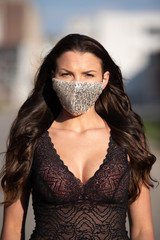 Woman with neckline wearing trendy fashion face mask due coronavirus Covid-19 protection
