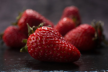 Directly above view of strawberry on black stone background.