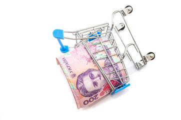 twisted into a roll 200 hryvnia in a shopping cart, isolated on a white background. Much money.