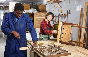 Restorers working with wooden furniture