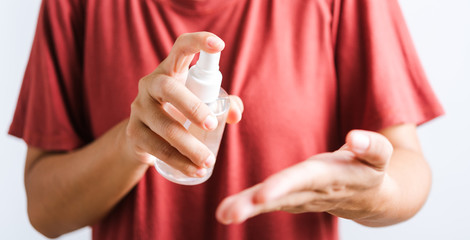 Closeup Hand Asian young woman applying spray pump dispenser sanitizer alcohol on hand wash cleaning, hygiene prevention COVID-19 or coronavirus protection concept, isolated on white background