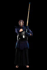 male in tradition kendo armor with shinai (bamboo sword). shot in studio. Isolated with clipping path on black background