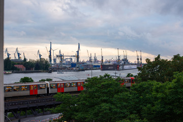 view of the port of hamburg over the elevated railway to the shipyard cranes