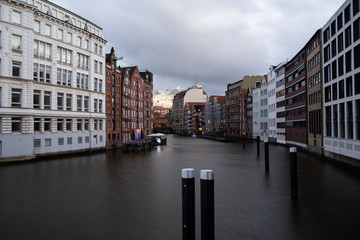 view of the elbphilharmonie Concert Hall in hamburg with water in the foreground under cloudy skies as a tourist attraction