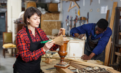 Restorers working with wooden details