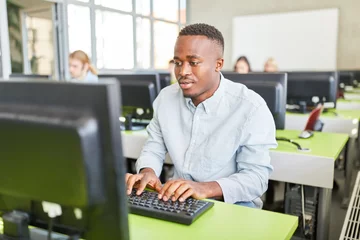 Fotobehang Afrikanischer Student im Computerkurs © Robert Kneschke