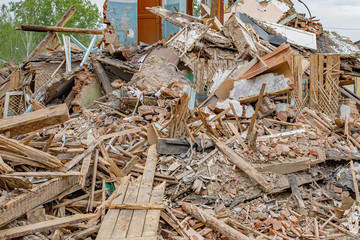 Rubble of old ruined house. Pile of construction fragments