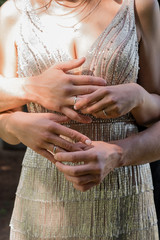 hands of man and woman with wedding rings. Wedding day. Gold rings on the hands of the newlyweds.