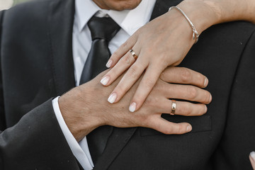 hands of man and woman with wedding rings. Wedding day. Gold rings on the hands of the newlyweds.