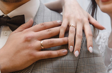 hands of man and woman with wedding rings. Wedding day. Gold rings on the hands of the newlyweds.