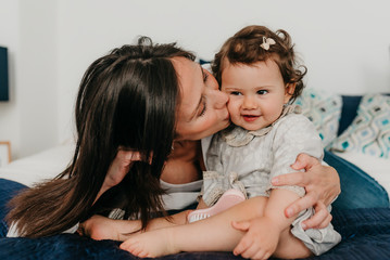 young pretty mother plays with her daughter