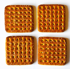 Shortbread brown homemade shortbread from the oven. Cookies are square in shape, flat with a hole, yellow, beige and brown.