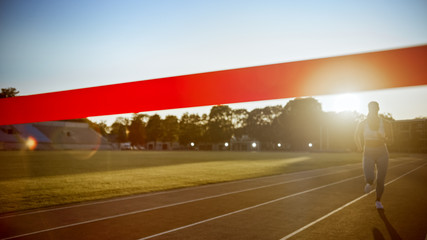 Beautiful Fit Female Runner Run Before Crossing the Finish Line on a Professional Sports Arena....