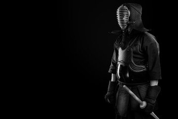 Male in tradition kendo armor with Samurai sword katana. shot in studio. Isolated on black...