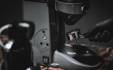 Grind coffee to make espresso.