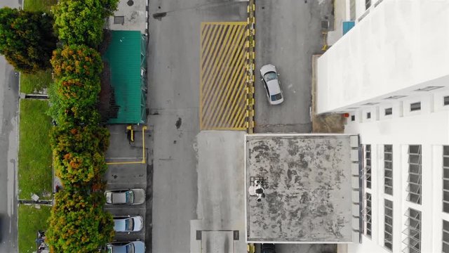 Top View Of Parking Lot As Car Parks At The Side - Moving Forward