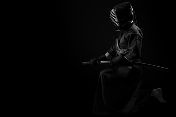 Male in tradition kendo armor with Samurai sword katana. shot in studio. Isolated on black...