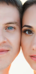 Male and female half face looking into camera