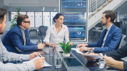 Group of Executives, Lawyers, Businesspeople and Investors Gather at the Table in Corporate Meeting...