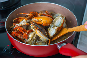 Salt and pepper stir-fired crab on the cooking pan