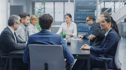 In the Modern Corporate Office Meeting Room: Diverse Group of Businesspeople, Lawyers, Executives and Members of the Board of Directors Talking, Negotiating and Working on a Winning Strategy. 