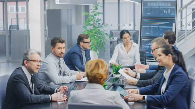 In the Modern Corporate Office Meeting Room: Diverse Group of Businesspeople, Lawyers, Executives and Members of the Board of Directors Talking, Negotiating and Working on a Winning Strategy. 