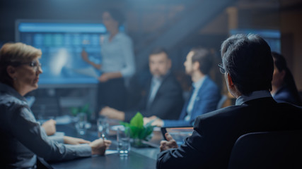 Late at Night In the Corporate Office Meeting Room: Executive Director Leads Hard Negotiations with Businesspeople. Over the Shoulder Back Shot 