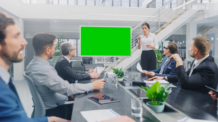 In the Corporate Meeting Room: Female Speaker Uses Digital Chroma Key Interactive Whiteboard for Presentation to a Board of Executives, Lawyers, Investors. Green Mock-up Screen in Horizontal Mode