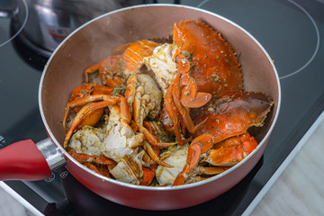Homemade stir-fried crab with salt and pepper in the pan