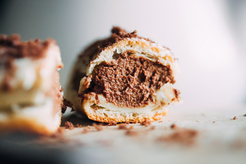 Cake eclairs with chocolate cream in a cut. Over-large plan. Macro. Traditional French dessert. Fast carbs. High sugar content