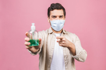 Young man in sterile face mask isolated on pink background. Epidemic pandemic coronavirus 2019-ncov...