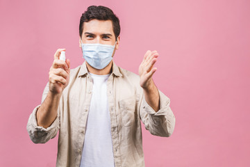 Young man in sterile face mask isolated on pink background. Epidemic pandemic coronavirus 2019-ncov...
